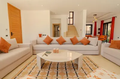 a living room with white couches and a coffee table at Villa Assia Modern Luxury Private Pool in Marrakech