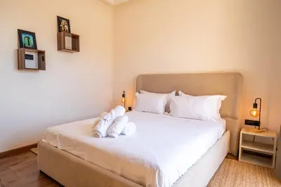 a bedroom with a bed with two white towels on it at Villa Assia Modern Luxury Private Pool in Marrakech
