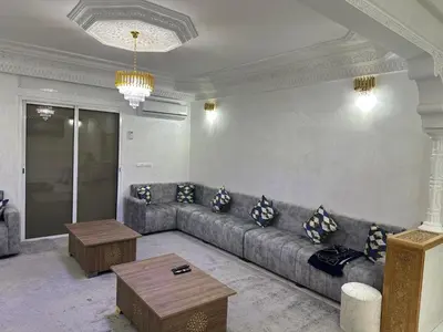 a living room with a couch and two tables at Achraf in Marrakech