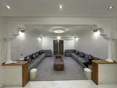 a waiting room with couches and a table in a building at Achraf in Marrakech