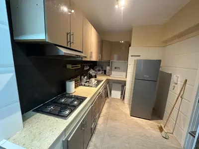 a kitchen with a stove and a refrigerator at Achraf in Marrakech