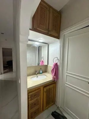 a bathroom with a sink and a mirror at Achraf in Marrakech