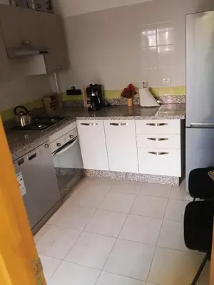 a kitchen with white cabinets and a counter top at Loger marrakech in Marrakech