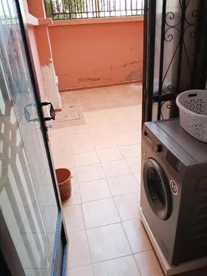 a washer and dryer sitting on a tile floor at Loger marrakech in Marrakech