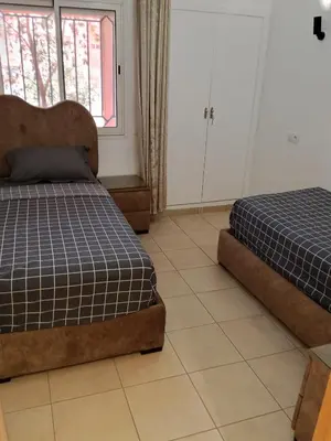 a bedroom with two beds and a window at Loger marrakech in Marrakech