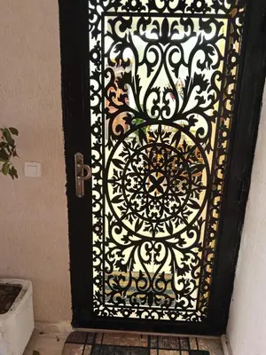 a black door with a black and white gate at Loger marrakech in Marrakech