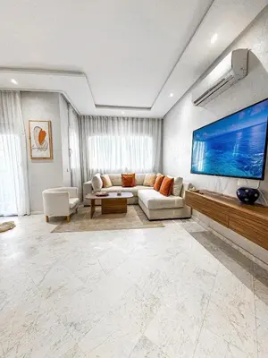 a living room with a couch and a large tv at Dream stay in Hivernage Pool-Balcony-Parking in Marrakech