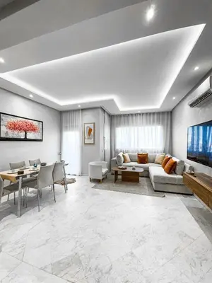 a living room with a couch and a tv and a table at Dream stay in Hivernage Pool-Balcony-Parking in Marrakech