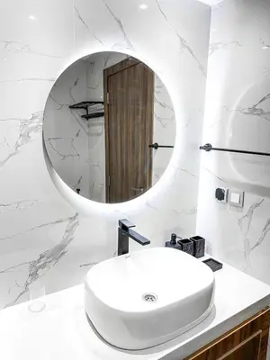 a white bathroom with a sink and a mirror at Dream stay in Hivernage Pool-Balcony-Parking in Marrakech
