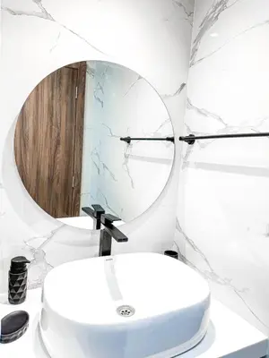 a bathroom with a white sink and a mirror at Dream stay in Hivernage Pool-Balcony-Parking in Marrakech