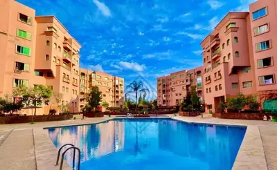 a large swimming pool in a courtyard with buildings at Dream stay in Hivernage Pool-Balcony-Parking in Marrakech