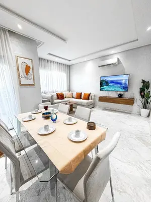 a living room with a table and a couch at Dream stay in Hivernage Pool-Balcony-Parking in Marrakech