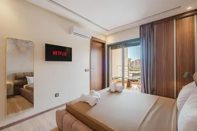 a bedroom with a bed with two towels on it at 2BR NEW Luxury apartment CityCenter in Marrakech