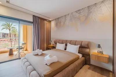 a bedroom with a large bed and a couch at 2BR NEW Luxury apartment CityCenter in Marrakech