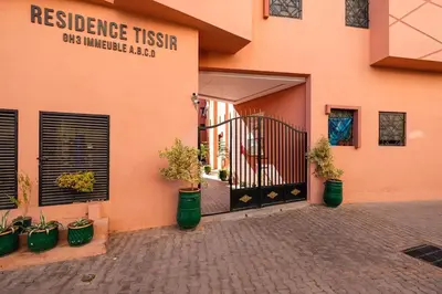 a building with a gate and potted plants in front of it at 5-min away to Marrakech Airport in Marrakech