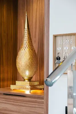 a gold vase sitting on top of a shelf at Airport RAK 2Br perfect for early & late flights in Marrakech