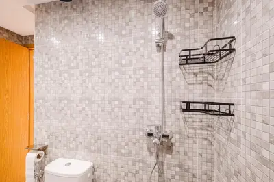 a bathroom with a shower with a basketball hoop at Airport RAK 2Br perfect for early & late flights in Marrakech