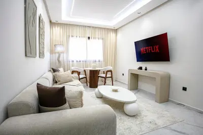 a living room with a couch and a table at The Pleasant Stay - Hivernage Marrakech in Marrakech