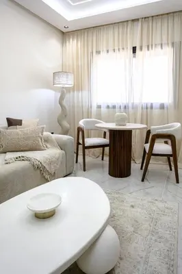 a living room with a couch and a table at The Pleasant Stay - Hivernage Marrakech in Marrakech
