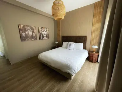 a bedroom with a bed and two pictures on the wall at Villa Corail in Marrakech