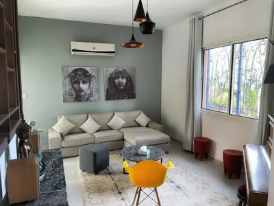 a living room with a couch and a table at Villa Corail in Marrakech