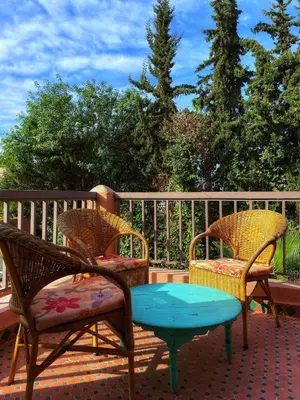 two chairs and a table on a deck at Villa Corail in Marrakech