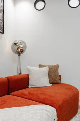 a orange couch sitting in a room with a lamp at The Icon Boutique Hivernage in Marrakech