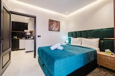 a bedroom with a blue bed with a green headboard at NEW 2Br Family-Friendly, in the Heart of Marrakech in Marrakech