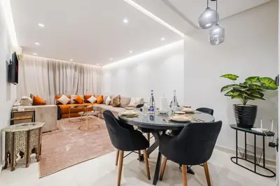 a living room with a table and chairs and a couch at NEW 2Br Family-Friendly, in the Heart of Marrakech in Marrakech