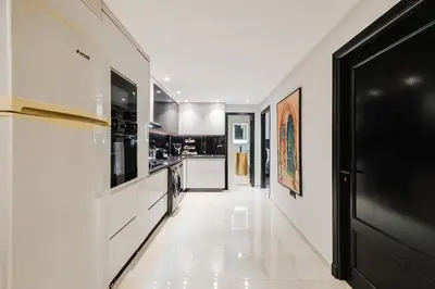 a kitchen with white walls and a black door at NEW 2Br Family-Friendly, in the Heart of Marrakech in Marrakech