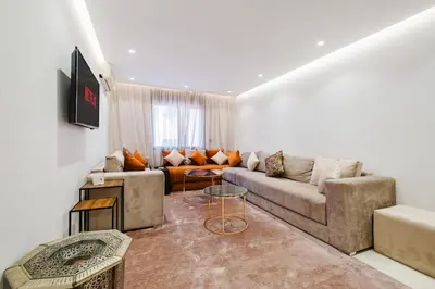 a living room with a couch and a table at NEW 2Br Family-Friendly, in the Heart of Marrakech in Marrakech