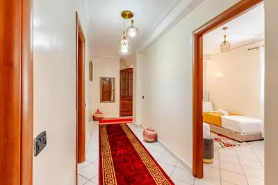 a hallway with a room with a bed and a red rug at Gueliz - Authentic 3 Majorelle central Marrakech in Marrakech