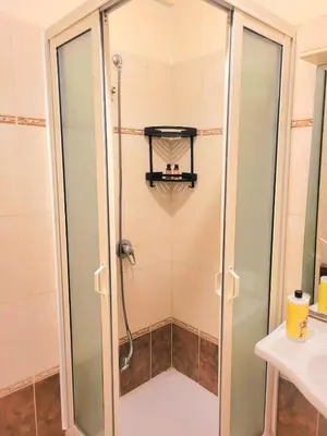 a shower with a glass door in a bathroom at Gueliz - Authentic 3 Majorelle central Marrakech in Marrakech