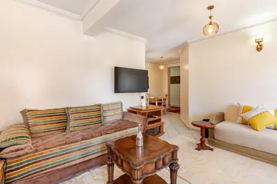 a living room with a couch and a tv at Gueliz - Authentic 3 Majorelle central Marrakech in Marrakech