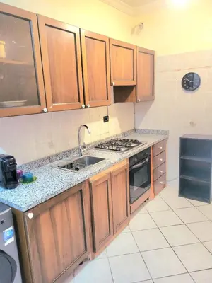 a kitchen with wooden cabinets and a sink at Gueliz - Authentic 3 Majorelle central Marrakech in Marrakech