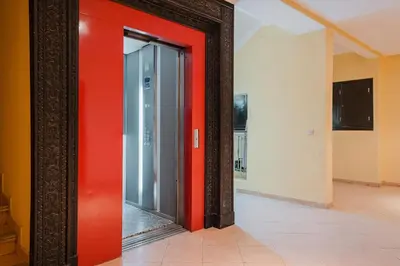 a red door in a room with a mirror at NEW 2Br Family-Friendly, in Center of Marrakech in Marrakech
