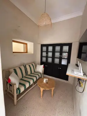 a living room with a couch and a coffee table at Riad Dar tiegezh in Marrakech