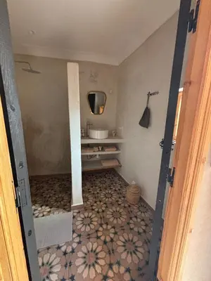 a bathroom with a sink and a mirror at Riad Dar tiegezh in Marrakech