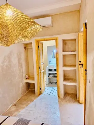 a room with an open door and a room with a kitchen at Riad Dar tiegezh in Marrakech
