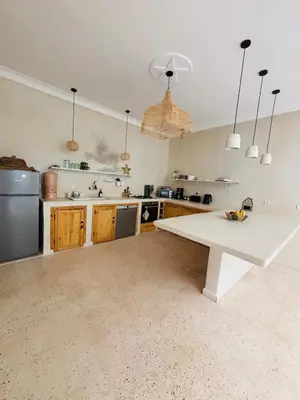 a large kitchen with a large white table in it at Riad Dar tiegezh in Marrakech