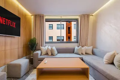 a living room with a couch and a coffee table at NEW 1BR Apart Queensize AC 5 min to CityCenter in Marrakech