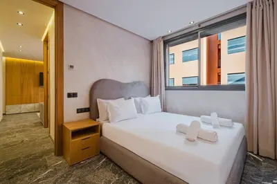 a bedroom with a large white bed with a window at NEW 1BR Apart Queensize AC 5 min to CityCenter in Marrakech
