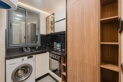 a kitchen with a washing machine and a sink at NEW 1BR Apart Queensize AC 5 min to CityCenter in Marrakech