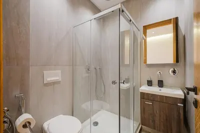 a bathroom with a shower and a toilet and a sink at NEW 1BR Apart Queensize AC 5 min to CityCenter in Marrakech