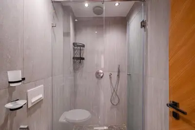 a bathroom with a shower with a toilet and a sink at New 2BR AC 5min from City Center-4 to 5Guests in Marrakech