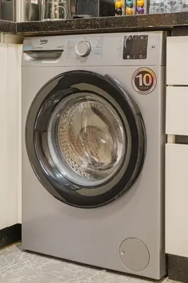 a washing machine is sitting in a kitchen at New 2BR AC 5min from City Center-4 to 5Guests in Marrakech