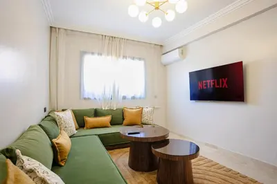 a living room with a green couch and two tables at The Luxury Gate Duplex Private Pool in Marrakech