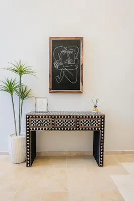 a table in a room with a chalkboard on the wall at The Luxury Gate Duplex Private Pool in Marrakech