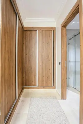 an empty room with wooden doors and a rug at The Luxury Gate Duplex Private Pool in Marrakech