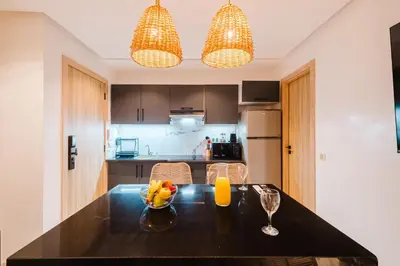 a kitchen with a table with a bowl of fruit on it at NEW Apartment Central 1BR-Queensize, AC&Terrace in Marrakech